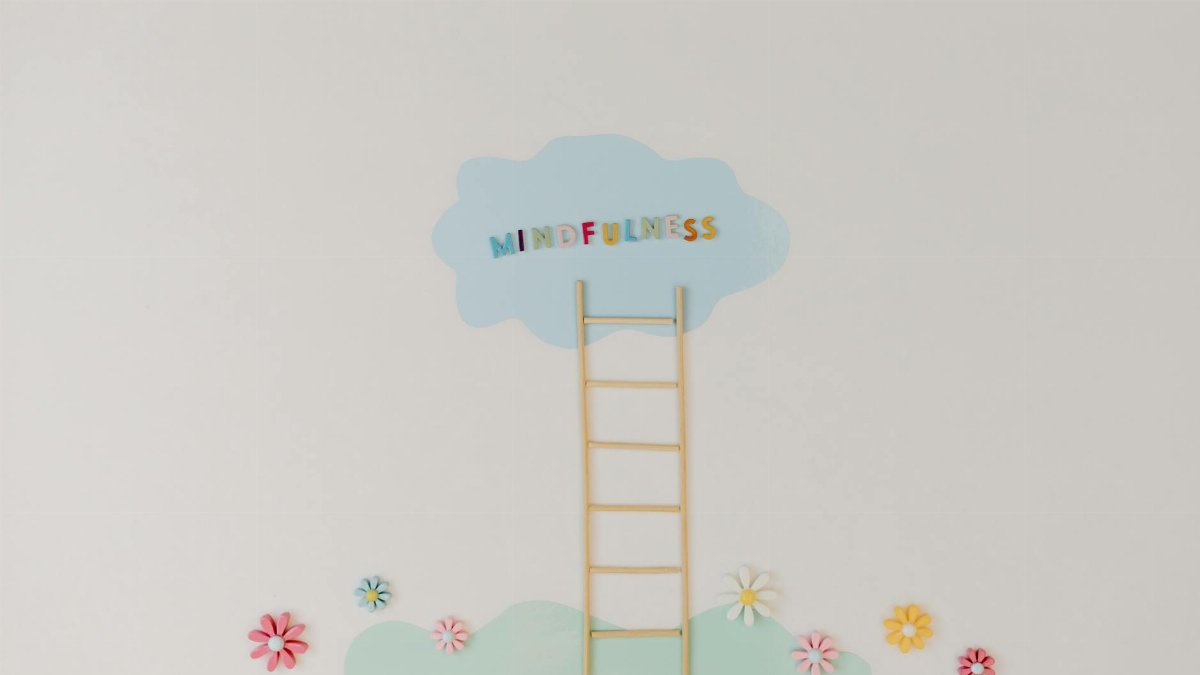 A minimalist conceptual art piece with a ladder leading to the word 'Mindfulness'.