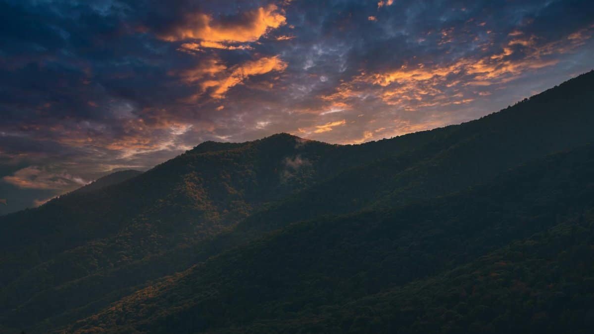 Breathtaking sunset over the Smoky Mountains with vivid skies and silhouetted peaks.