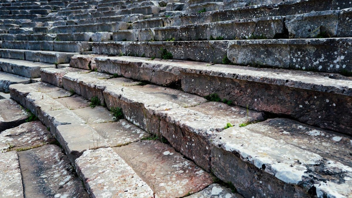 Close-up view of weathered stone steps in a historic Roman amphitheater, showcasing ancient architecture.