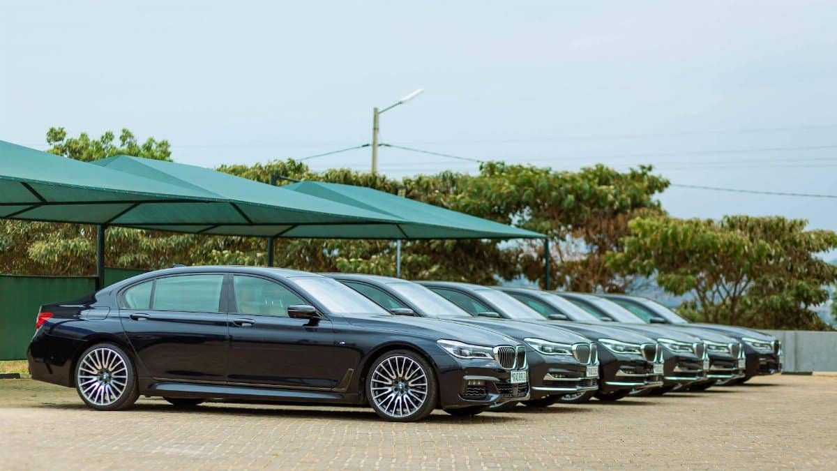 Lineup of luxury BMW Series 7 cars parked outdoors, showcasing elegance and style.