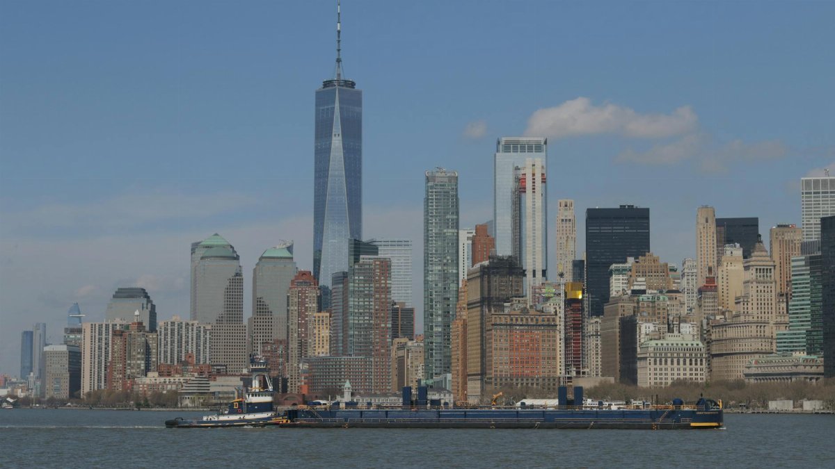 Stunning view of the New York City skyline featuring the iconic One World Trade Center across the Hudson River.
