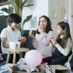 A lively indoor children's party featuring kids enjoying donuts and balloons. Perfect celebration vibes.