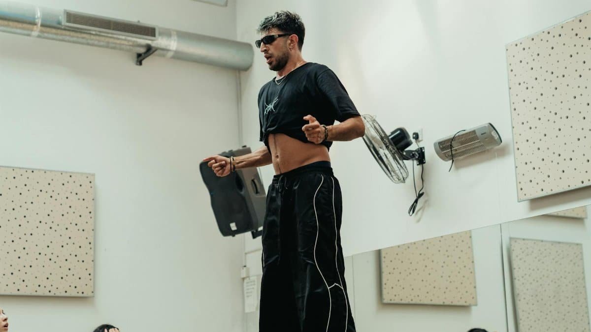 Energetic dance instructor leading a vibrant indoor class, inspiring with dynamic moves.