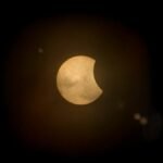 Captured partial solar eclipse set against a deep dark sky, perfect for astronomy enthusiasts.