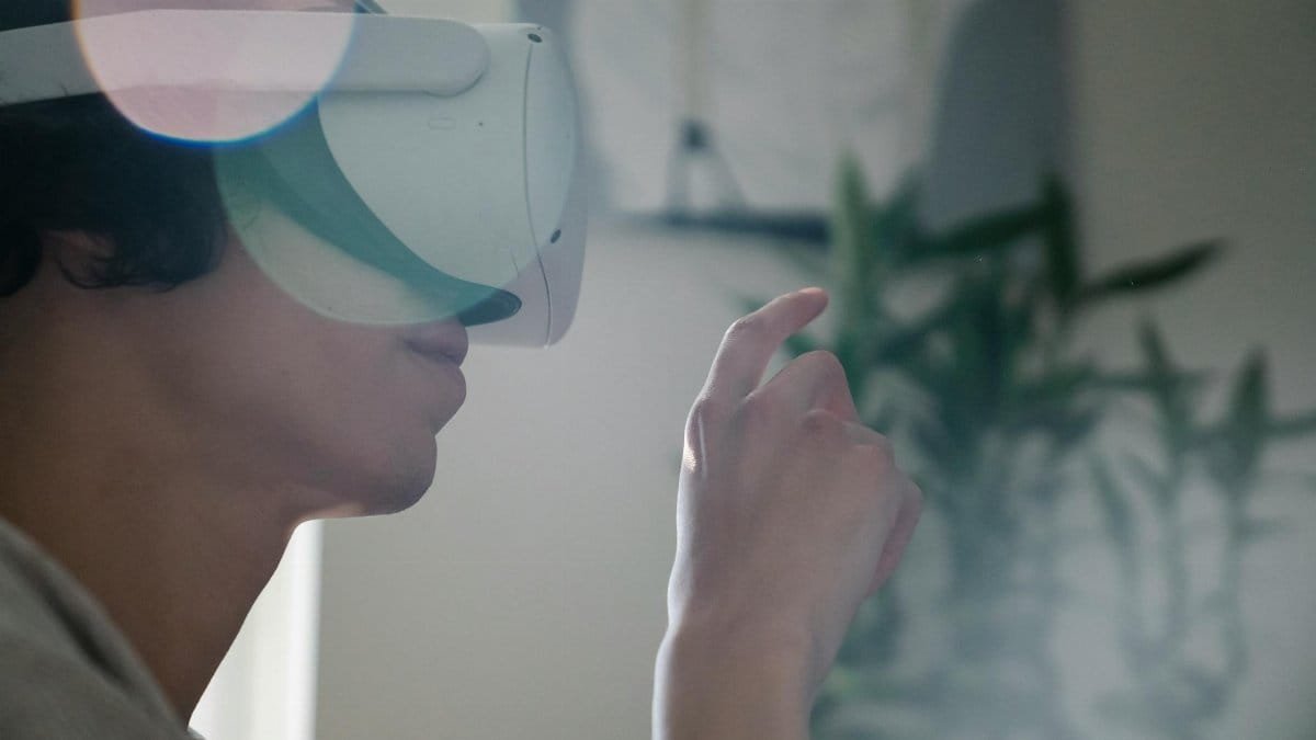 Young man engaging with virtual reality headset indoors, experiencing immersive technology.