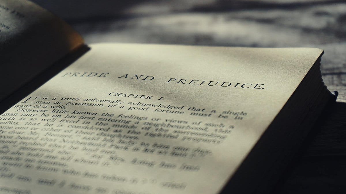 Close-up view of an open vintage page from Pride and Prejudice in warm sunlight.