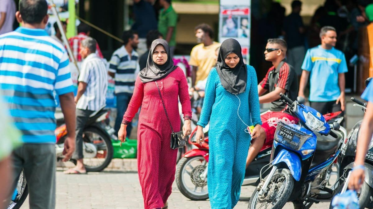 Capturing a bustling street scene with people walking and vibrant motorbikes.