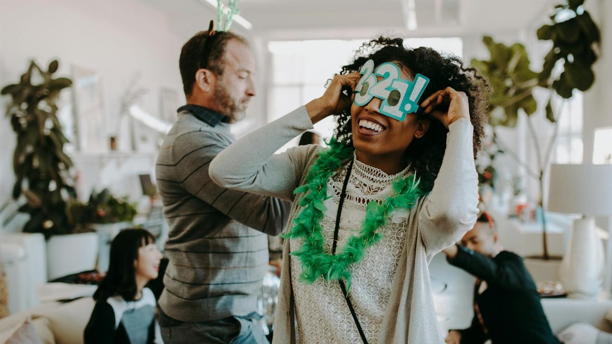 People enjoying a vibrant New Year celebration indoors, filled with laughter and festive decorations.