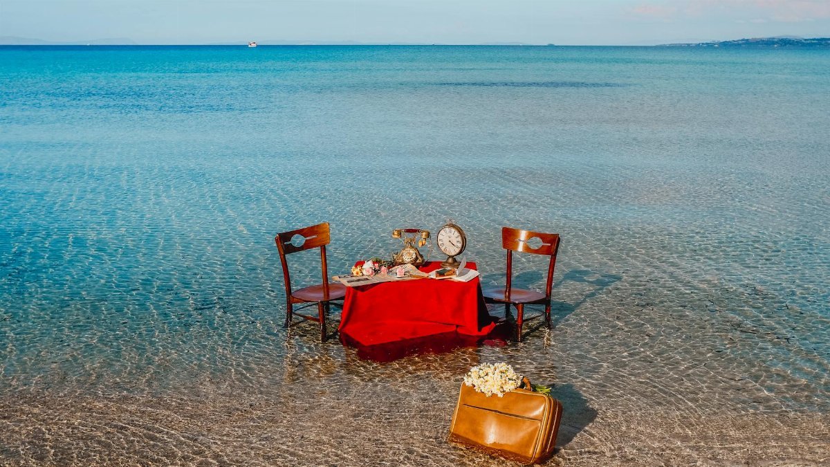 An enchanting vintage dining setup on a serene seashore with a nostalgic retro vibe.