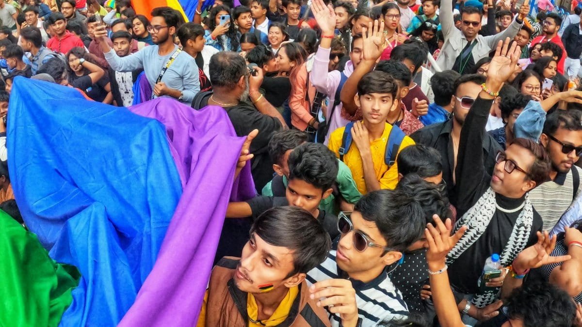 Lively Pride parade in Kolkata with a diverse crowd celebrating unity and diversity.