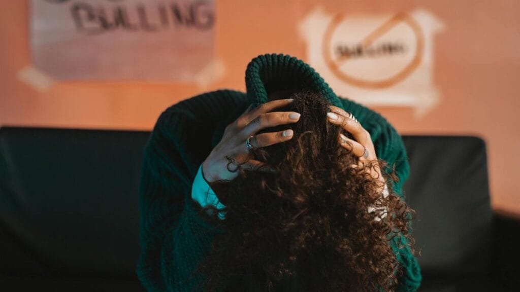 A person in distress, highlighting bullying awareness and mental health issues with a focus on anti-bullying.