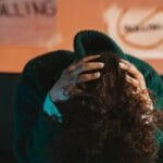 A person in distress, highlighting bullying awareness and mental health issues with a focus on anti-bullying.