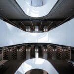 A sleek and contemporary library interior, showcasing modern architectural design and ample natural lighting.