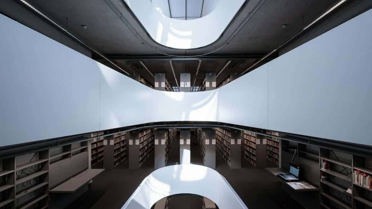 A sleek and contemporary library interior, showcasing modern architectural design and ample natural lighting.