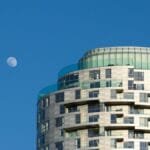 Contemporary high-rise building with the moon overhead in Lonoke, Arkansas.
