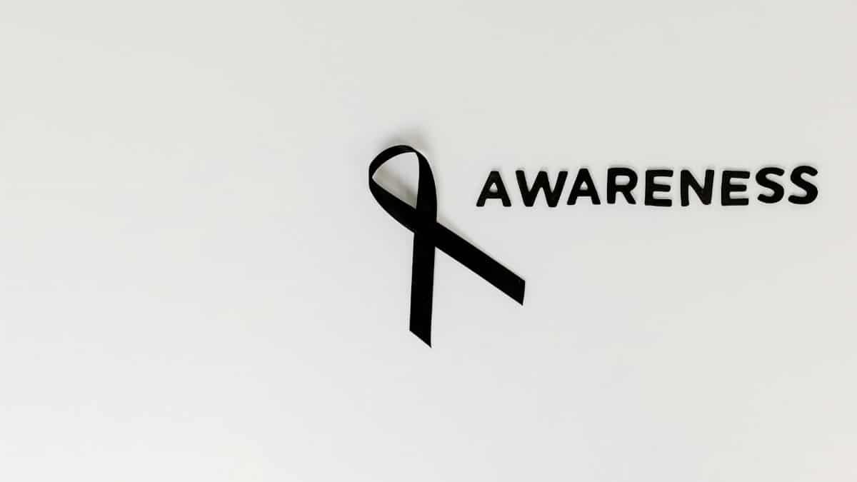 Conceptual image of a black ribbon with 'awareness' text on white background.