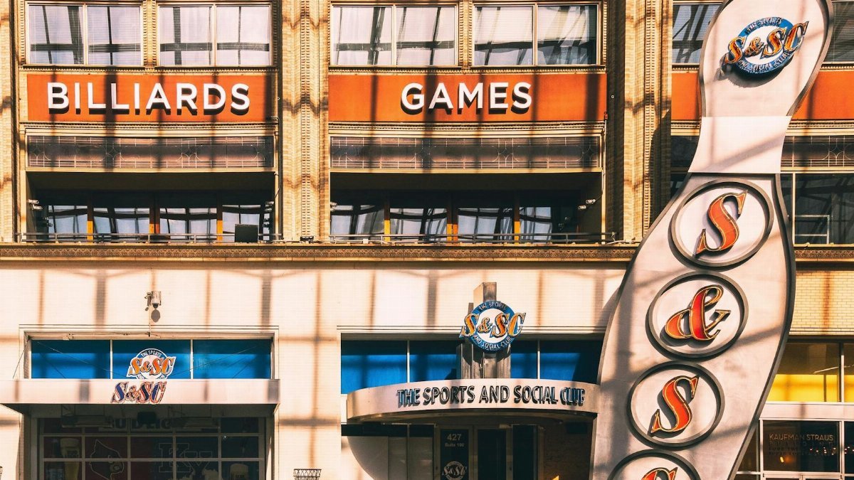 Facade of The Sports and Social Club with billiards sign in Louisville, KY.
