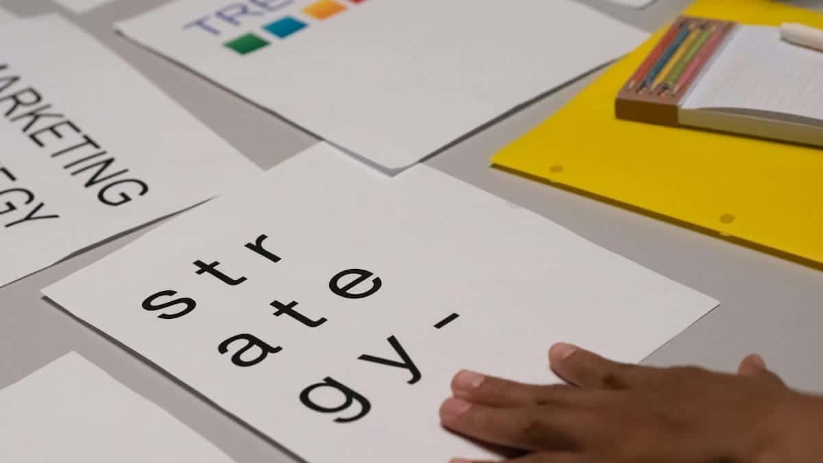Close-up of marketing strategy notes and colorful trends sheet on a table for planning session.