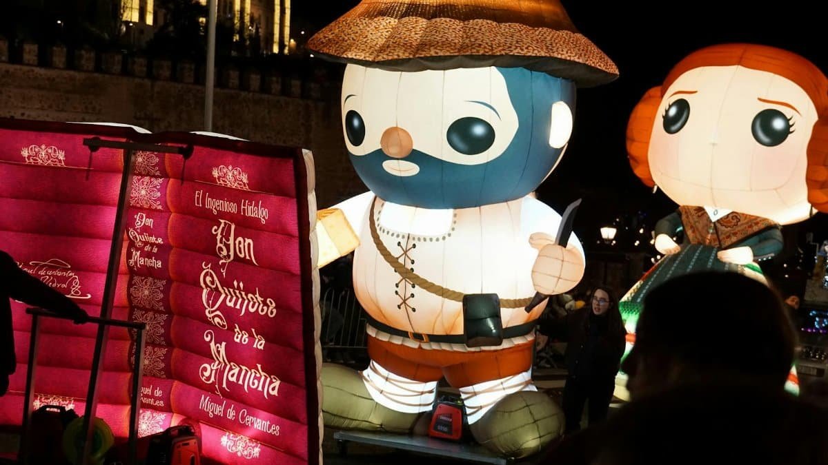 Large illuminated Quijote figures at night festival, capturing joyous celebration vibes.
