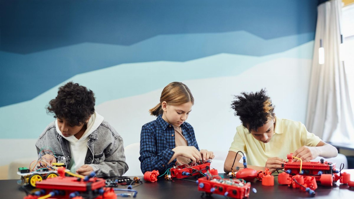 Children working on robotics projects in a classroom setting, learning and engaging.
