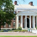 Elegant brick university building with columns in Burlington, VT.