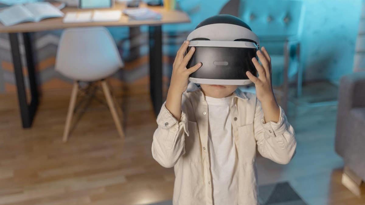 Young child immersed in virtual reality with VR headset indoors.