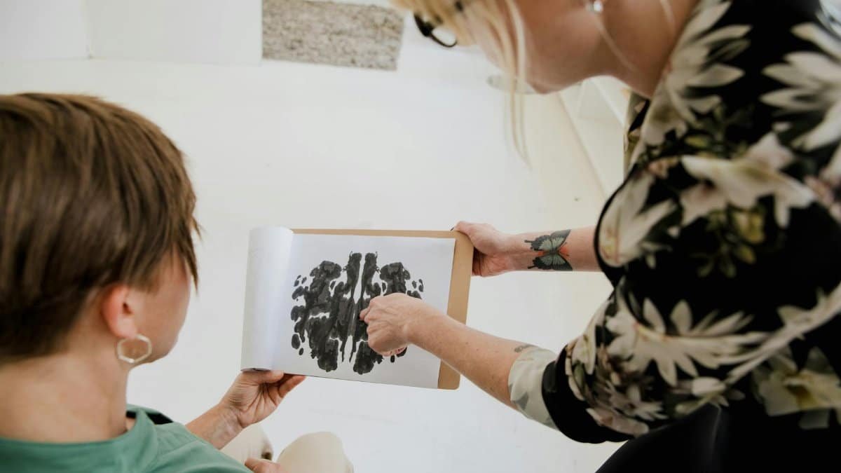 Therapist discussing Rorschach inkblot test with a client in a therapy session.