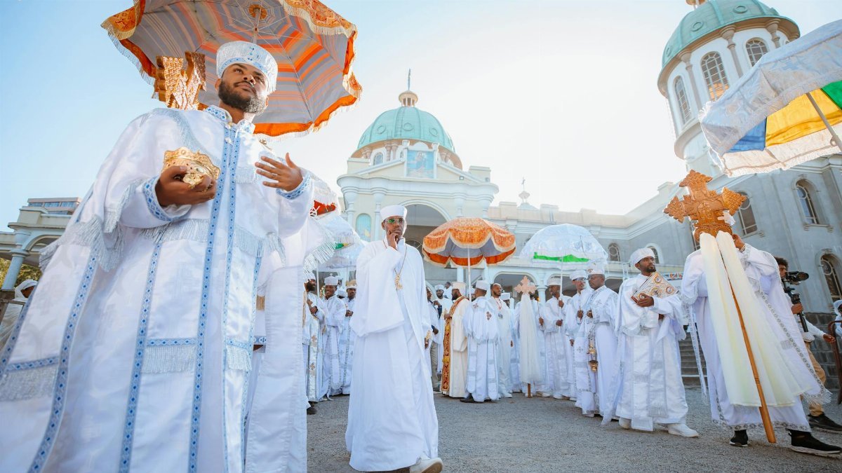 Orthodox religious procession at a church in Addis Ababa, Ethiopia, showcasing traditional attire and rituals.
