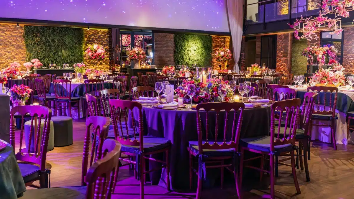 Lavishly decorated wedding reception with floral arrangements and elegant table settings.