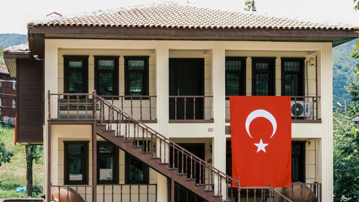 A charming traditional Turkish house displaying the national flag, symbolizing national pride.