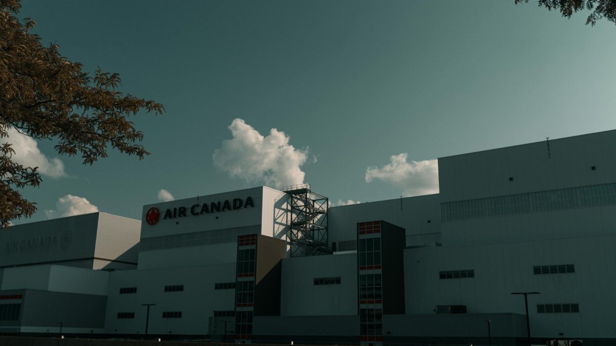 An Air Canada warehouse building with a clear sky background, capturing modern architecture.