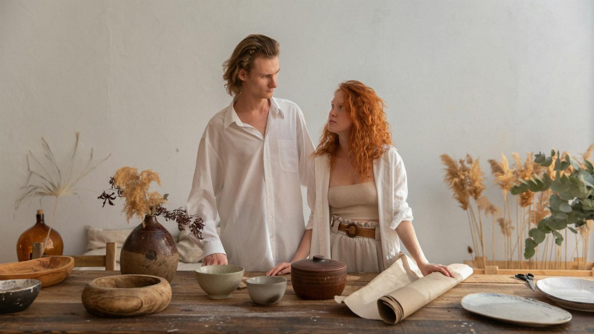 A couple working together in a trendy workshop, surrounded by handmade pottery and decor