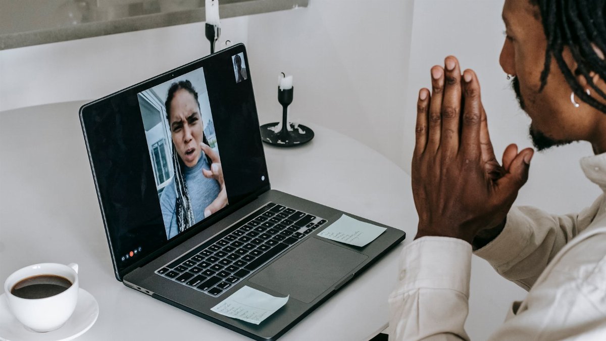 Anxious misunderstanding African American couple having video call via laptop and arguing emotionally while going through relationships crisis