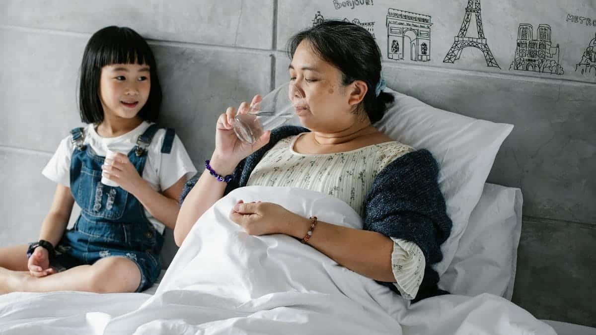 Elderly woman and granddaughter sharing a moment in a cozy home setting.
