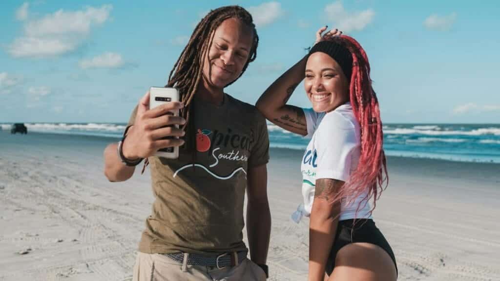 Happy couple capturing a selfie on a sunny day at New Smyrna Beach, Florida.