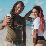 Happy couple capturing a selfie on a sunny day at New Smyrna Beach, Florida.