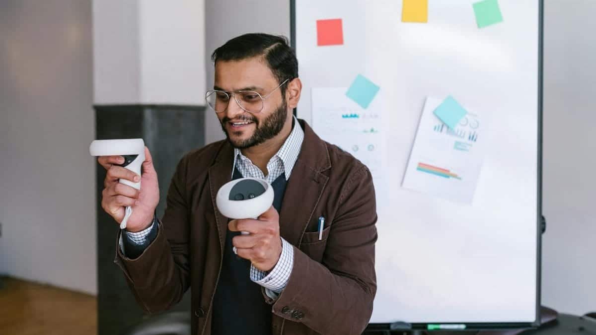 A business professional demonstrating virtual reality controllers during a presentation.