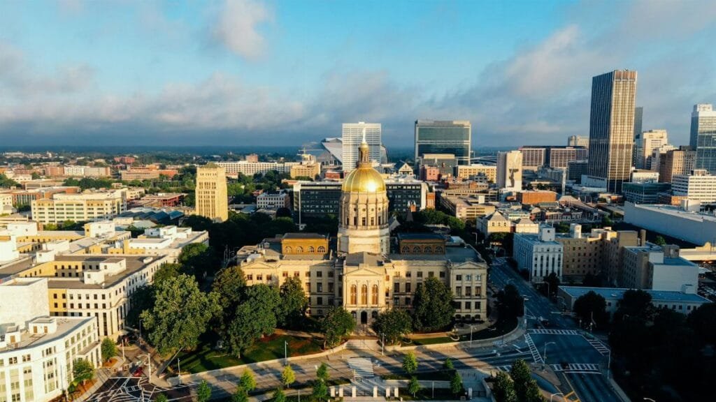 Stunning aerial view of the Georgia State Capitol in downtown Atlanta under a clear blue sky.