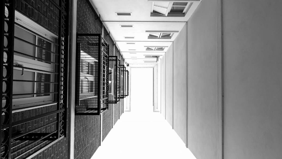 Monochrome view emphasizing modern architectural symmetry with glass windows and steel framework.
