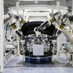 High-tech robots assembling a car in a modern factory setting, showcasing automation.