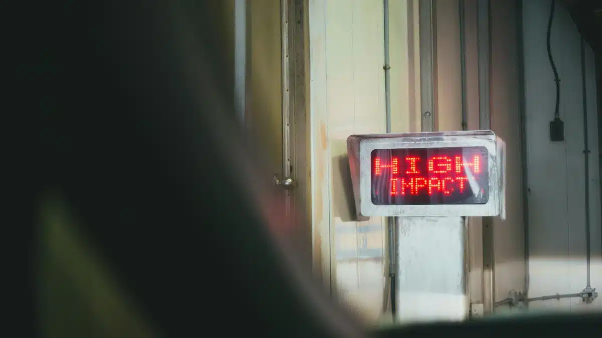 A red LED sign displaying 'HIGH IMPACT' in an indoor setting.