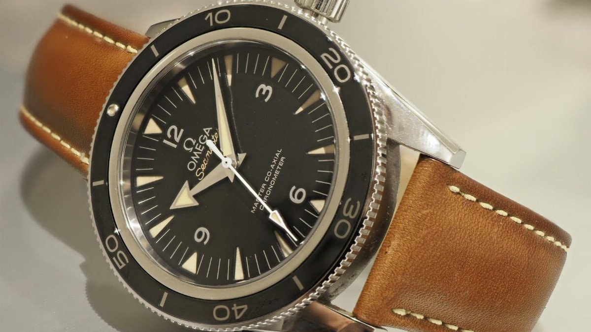 Detailed close-up of an Omega wristwatch showcasing elegant design with leather strap.