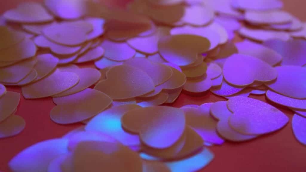 Scattered heart-shaped confetti creating a romantic and vibrant atmosphere, perfect for celebrations.