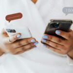 A woman in a white robe interacts with two smartphones, showcasing social media engagement icons.