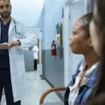 Doctor in a healthcare setting consulting patients, promoting health and wellness.