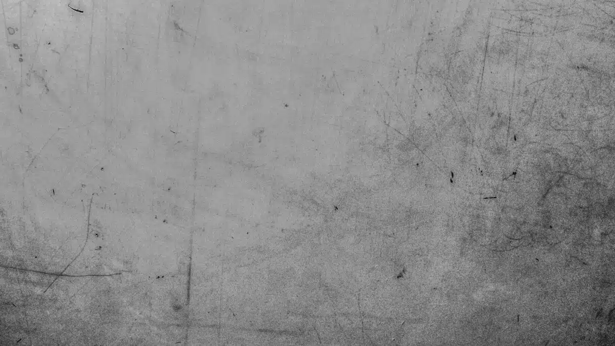 Detailed view of a textured grey surface with visible scratches and marks.