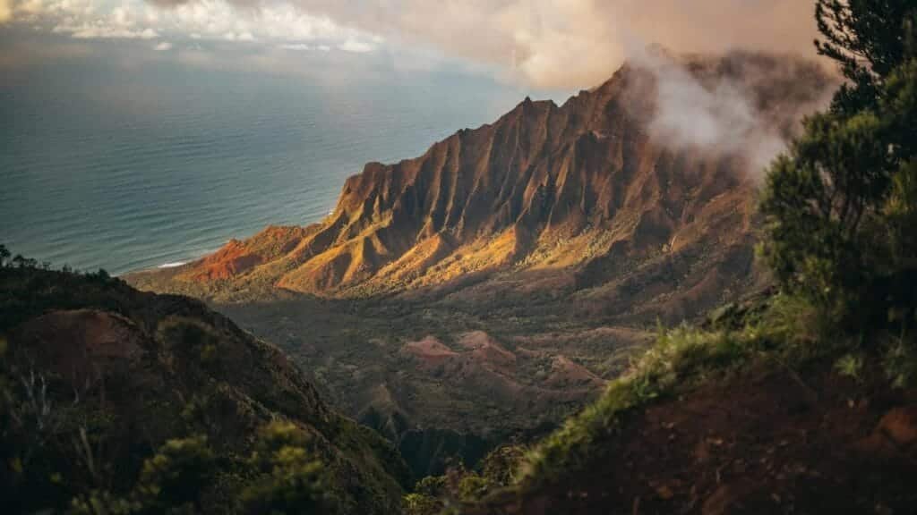 A stunning view of the Kalalau Valley with mountains and ocean in Kauai, Hawaii.