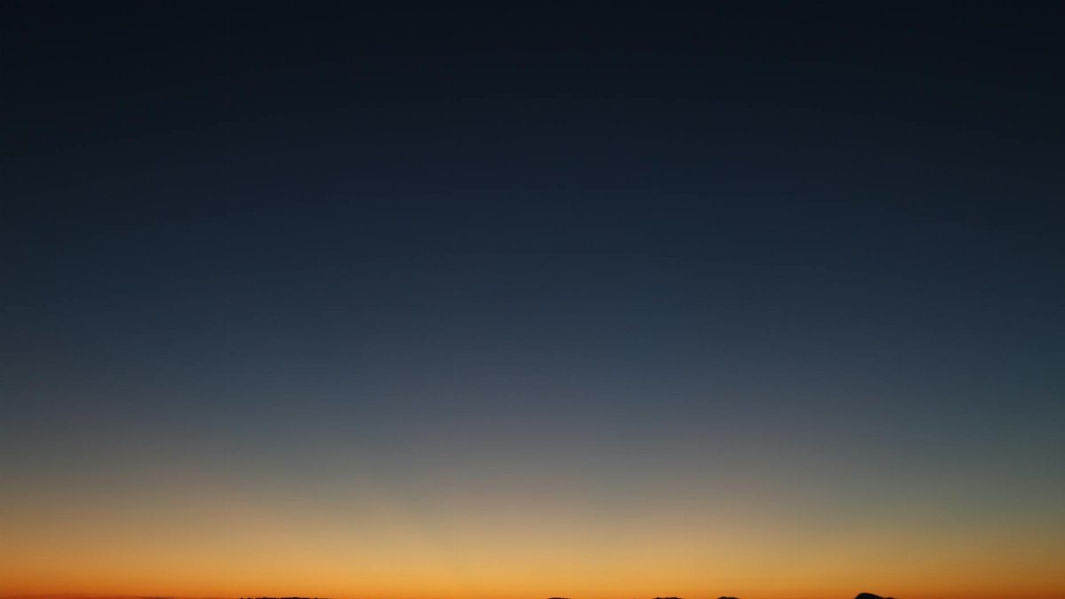Beautiful sunset over an island silhouette with a colorful sky, perfect for nature and travel themes.