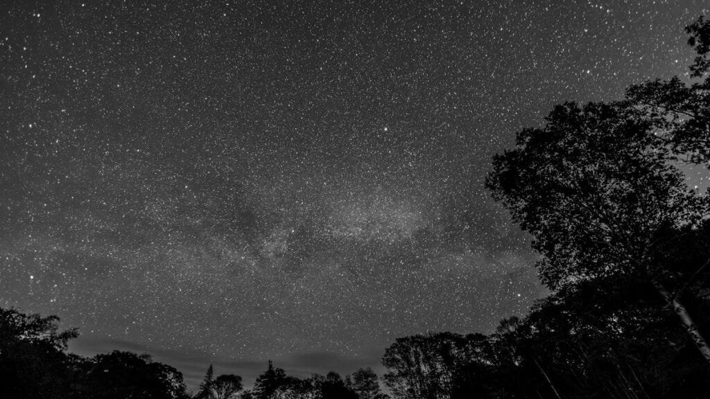 Captivating black and white view of a star-filled sky over Bristol, Maine.