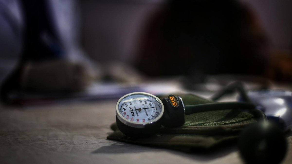 Detailed image of a medical sphygmomanometer on a table, indicating health check-up setting.